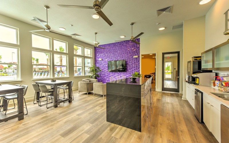 a large kitchen with a large purple flower arrangement