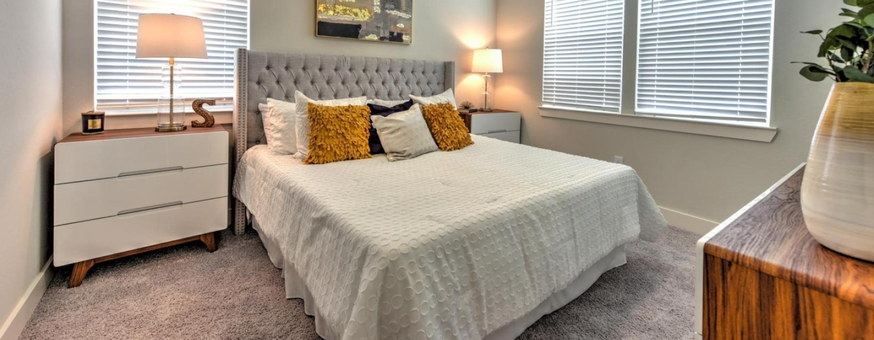 a bedroom with a bed and lamps